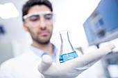 Lab assistant holding chemical flask