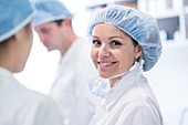 Female surgeon wearing surgical cap