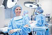 Female surgeon in scrubs smiling
