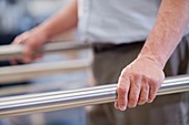 Man using parallel walking bars in hospital