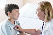Boy smiling towards nurse with stethoscope