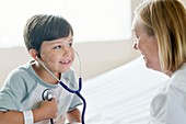 Boy smiling towards nurse wearing stethoscope