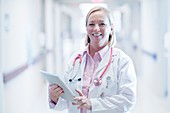 Mature nurse using digital tablet in hospital