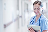 Nurse wearing blue uniform usingdigital tablet
