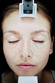 Image of young woman's face in skin clinic
