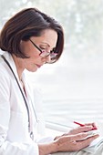 Female doctor wearing glasses with device