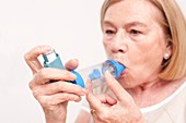 Senior woman using an inhaler