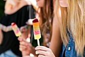 Woman holding ice lolly