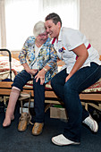 Nurse hugging an elderly woman