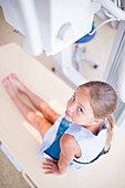 Girl about to have x-ray looking at camera