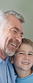 Portrait of grandfather and grandson smiling