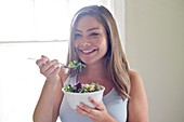 Woman eating salad