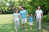 Family walking in park holding hands