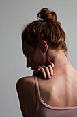 Woman touching her neck and back