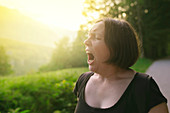 Woman yawning outdoors