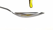 Olive oil on spoon, slow motion
