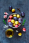 Cooking background with fresh potatoes, garlic and olive oil over dark grunge table
