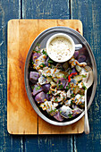 Herring and purple potatoes salad with pickled cucumber and mustard