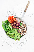 A vegetable bowl with peppers, colourful carrots, shiitake mushrooms and mange tout