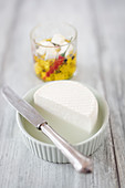 Homemade feta, in a ramekin and on a salad