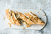 A party baguette with dried apricots, Brie and nuts