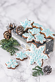 Gingerbread cookies decorated with white and blue royal icing