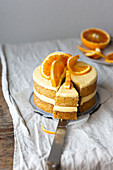 A layered orange cake, sliced
