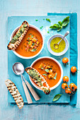 Tomato soup with salsa and grilled bread with basil pesto, view from above