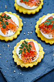 Marinated salmon with crème fraîche on homemade crackers