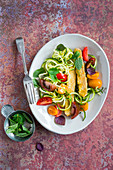 Tempeh with zucchini and tomatoes salad