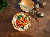 A stir fry with radish, bok choy, and peppers on rice (Asia)