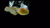 Apple falling in water, slow motion