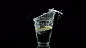 Lime falling in water, slow motion