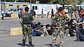 Greek soldiers guard Syrian migrants