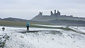 Woman in a storm on the coast