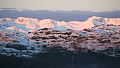 Dawn light on snowy peaks