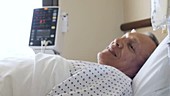 Man lying in hospital bed
