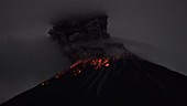 Reventador volcano erupting at night