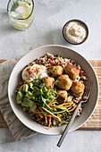 Bulgur wheat with chicken balls, vegetables and micro herbs