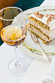 A slice of chestnut cake with a glass of dessert wine