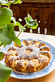 Apple cake with flaked almonds and icing sugar