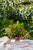 Flower arrangement with ornamental peppers on outdoor table