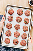 Turkish meatballs being made: raw meatballs on a baking tray