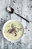 Potato, broccoli and cheese soup with red sprouts