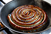 A sausage snail in a pan