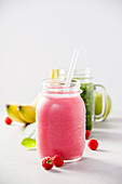 Close-up of pink fresh smoothie with fruits and berries