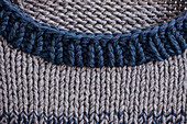 A hand-knitted men's jumper (detail of neckline)