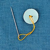 A button being sewn on