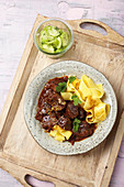 Classic goulash with tagliatelle and cucumber salad