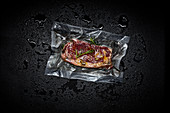 Beef steak with herbs in a sous vide bag